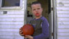 A young boy shows off his Halloween jack-o-lantern.