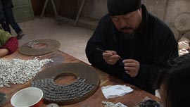 Ai Weiwei paints handcrafted porcelain sunflower seeds in Jingdezhen, China.