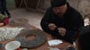 Ai Weiwei paints handcrafted porcelain sunflower seeds in Jingdezhen, China.