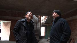 Ai Weiwei and art assistant Inserk Yang inspect the construction of a new studio in Shanghai in 2010.