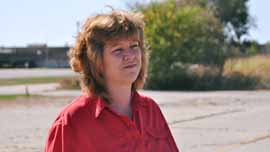 Cindy Deegan waits to be interviewed in front of ALCOA, where she used to work.