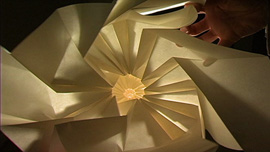 Material artist Chris K. Palmer experimenting in paper with pattern, movement and a flood light