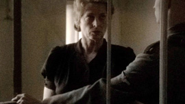 Catherine Senesh (Marcela Nohýnková) being led to her prison cell