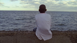Main character Denick staring out at the sea on the main boulevard of Cap-Haitien