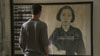 Nic Dunlop in the Tuol Sleng gallery at photo of Chan Kim Srun