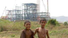 The development of India juxtaposed with children who are supposed to benefit. The development of India juxtaposed with children who are supposed to benefit.