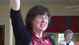 Beverly May cheers at a meeting to protect Wilson Creek.