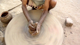 A street potter showing what he can do with dirt