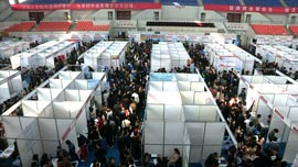 Recent graduates search for employment at a job fair. Recent graduates search for employment at a job fair.
