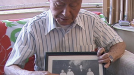 Paul Loong points out his family while he grew up in Malaysia