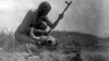 Black and white photo of Plains Indian with bison skull and prayer pipe