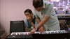 Javier gives rehearses at the keyboards with Godwin Lee.