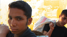 Adham and Nabil carrying garbage 
