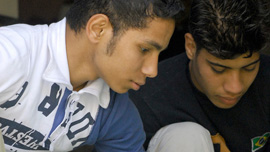 Adham and Nabil sorting shampoo bottles at the recycling school