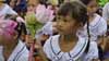 A girl holds flowers during Room to Read's 10 millionth book ceremony in Vietnam.