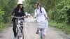 Gabrielle Union and local student Duyen Le ride bikes in Thu Thua, Vietnam.