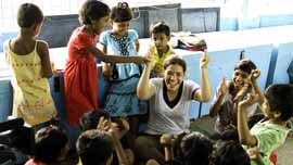 America Ferrera plays with children at the New Light Crèche in Kolkata, India.