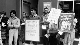 Anti-apartheid demonstrators protest Barclays Bank's involvement in South Africa. United Kingdom, 1980's