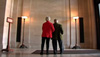 Herb and Dorothy at the National Gallery of Art in Washington, DC, viewing the benefactors list