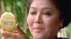 Imelda looks herself in a compact