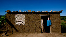 Vedastus in the doorway of his home, Ukerewe Island Tanzania.