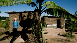 Vedastus stands by his house, Ukerewe Island, Tanzania.
