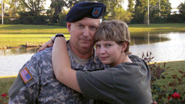 Seaman Recruit Hannah Sewell, US Navy, embraces her father Sergeant Major Jerry Sewell.
