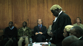 Tom Cholmondeley with defense lawyer Fred Ojiambo