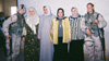 Specialist Shannon Morgan posing with Iraqi women in Ramadi, Iraq, 2004