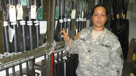 Specialist Rebecca Nava in arms room at Fort Riley, Kansas