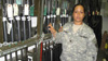 Specialist Rebecca Nava in arms room at Fort Riley, Kansas