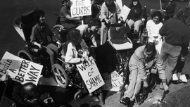 Protesters break a curb in the mid-1980s