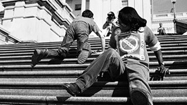 ADAPT protesters climb the steps to the Capitol on March 12th 1990