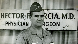Hector Garcia in front of his medical clinic