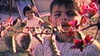 Gino Garcia peeks behind a bush as his sister Gaby smiles behind him in their 8mm home movie