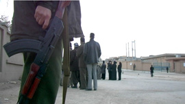Voters wait in line under heavy security
