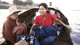 Socheata Poeuv on Mekong River in Cambodia with local fisherwoman