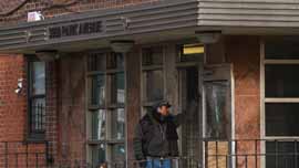 Man standing in front of 3050 Park Avenue in the South Bronx