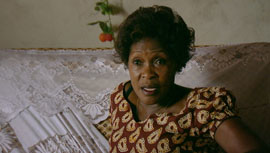 Betty Bigombe sitting on her couch
