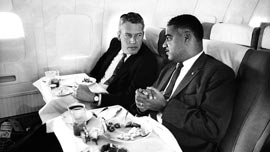 Whitney Young on a plane with a businessman 