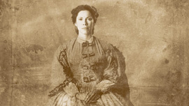 Loreta Velazquez (Romi Dias) poses for a portrait, dressed as a woman, played by Romi Diaz