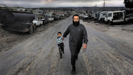Abu Amar al Azzam with his son Abu Bakr al Azzam in Zarqa, Jordan’s second largest city
