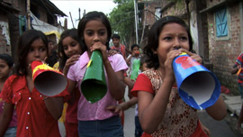 Child activists working with Amlan, marching through the streets of Calcutta using megaphones to spread health messages