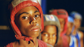 Close up image of young Cuban boxer Christian Martinez, with other young boxers in the background Close up image of young Cuban boxer Christian Martinez, with other young boxers in the background