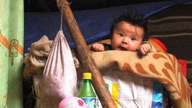 Pale chubby baby in her crib