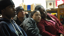 Anthony, Joel, Karina, and Pearl listening to another student read at the library