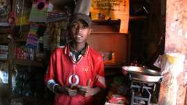 Biruk, who narrates Town of Runners, standing in his kiosk Biruk, who narrates Town of Runners, standing in his kiosk