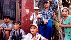 Street kids in Vietnam who wander Ho Chi Minh City selling postcards, trinkets and lottery tickets