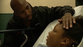 Demia Bruce comforts his daughter Deja Bruce in The Waiting Room
