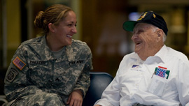 Bill Knight talks with a female soldier at the airport